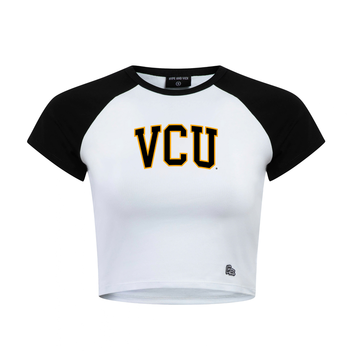 A white and black raglan crop top t-shirt featuring 'VCU' printed in black and gold block letters on the chest